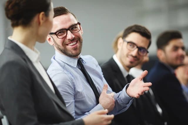 Tre colleghi che esaminano insieme dei documenti in ufficio